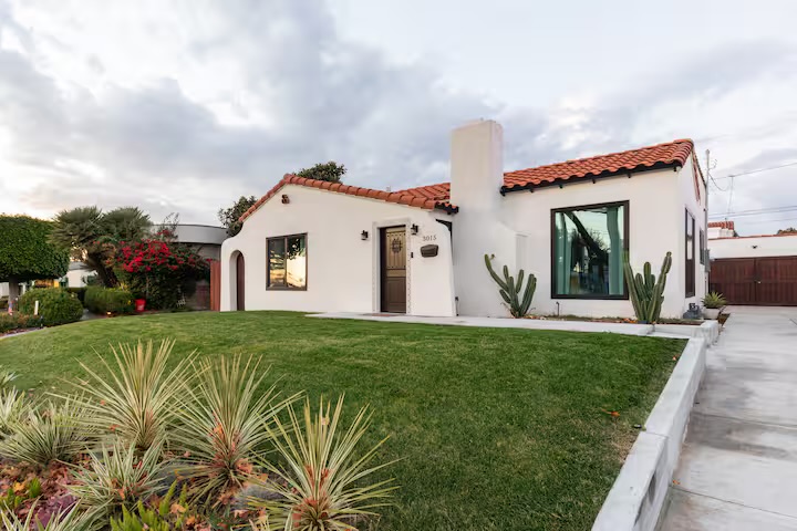 Casa Alhambra Spanish villa exterior at golden hour with olive tree